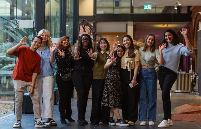 group of people waving and smiling